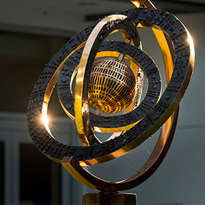 a brass globe statue part of the art on display in Freeman's GWBC.